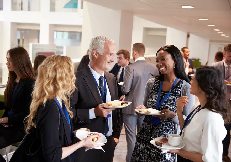 Delegates talking together over lunch at a networking event